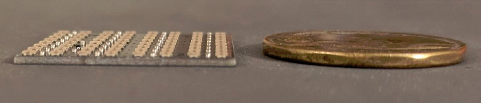 The side of an array showing the thickness compared to a Canadian loonie.
